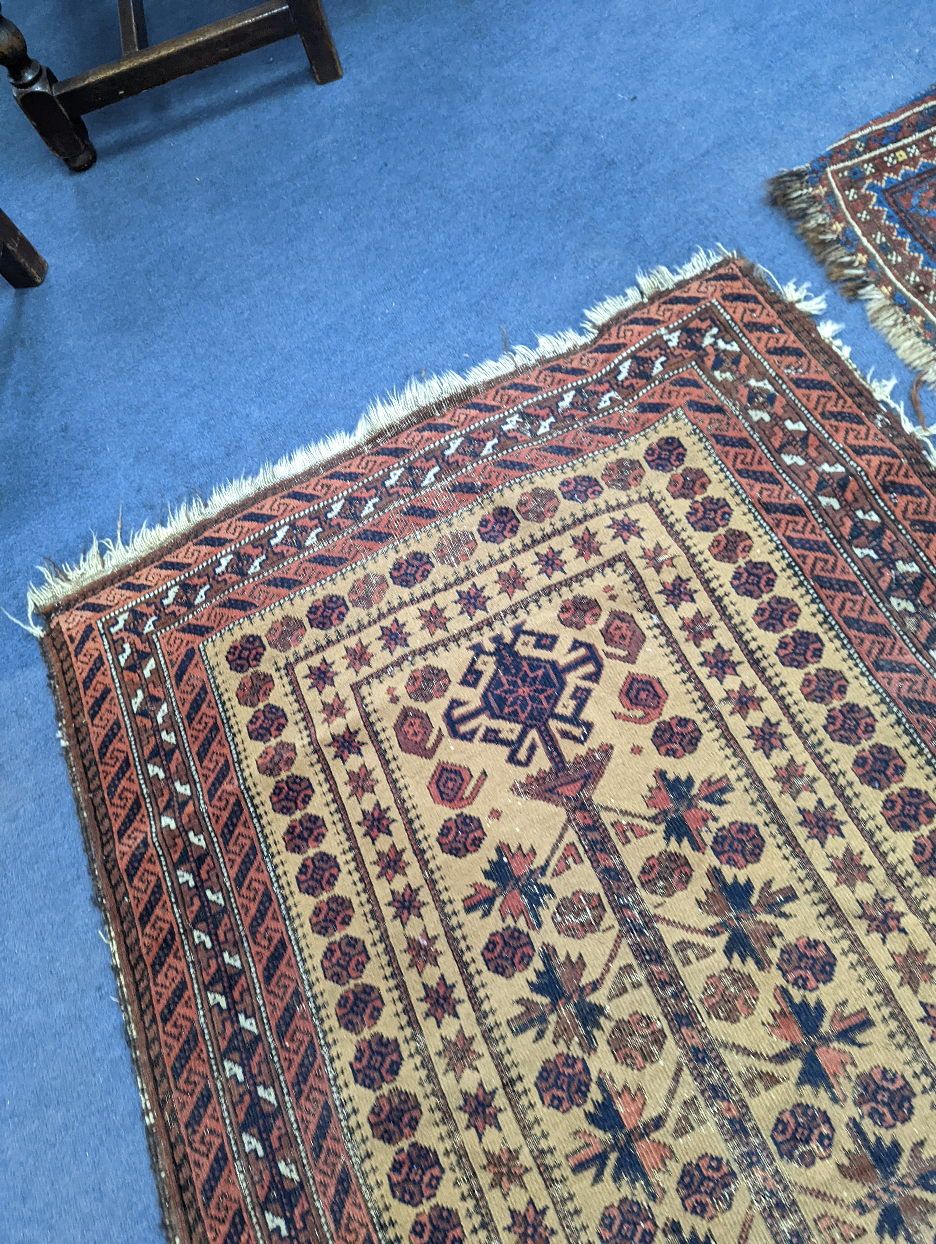 A Caucasian red ground rug and a Belouch rug, larger 200 x 165cm